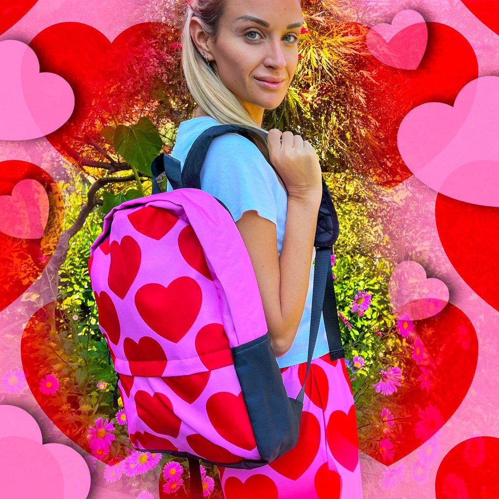 A woman with a colorful ELLIE LOVE red backpack by SHALMIAK. Yes, our colorful backpacks are great for adults too.