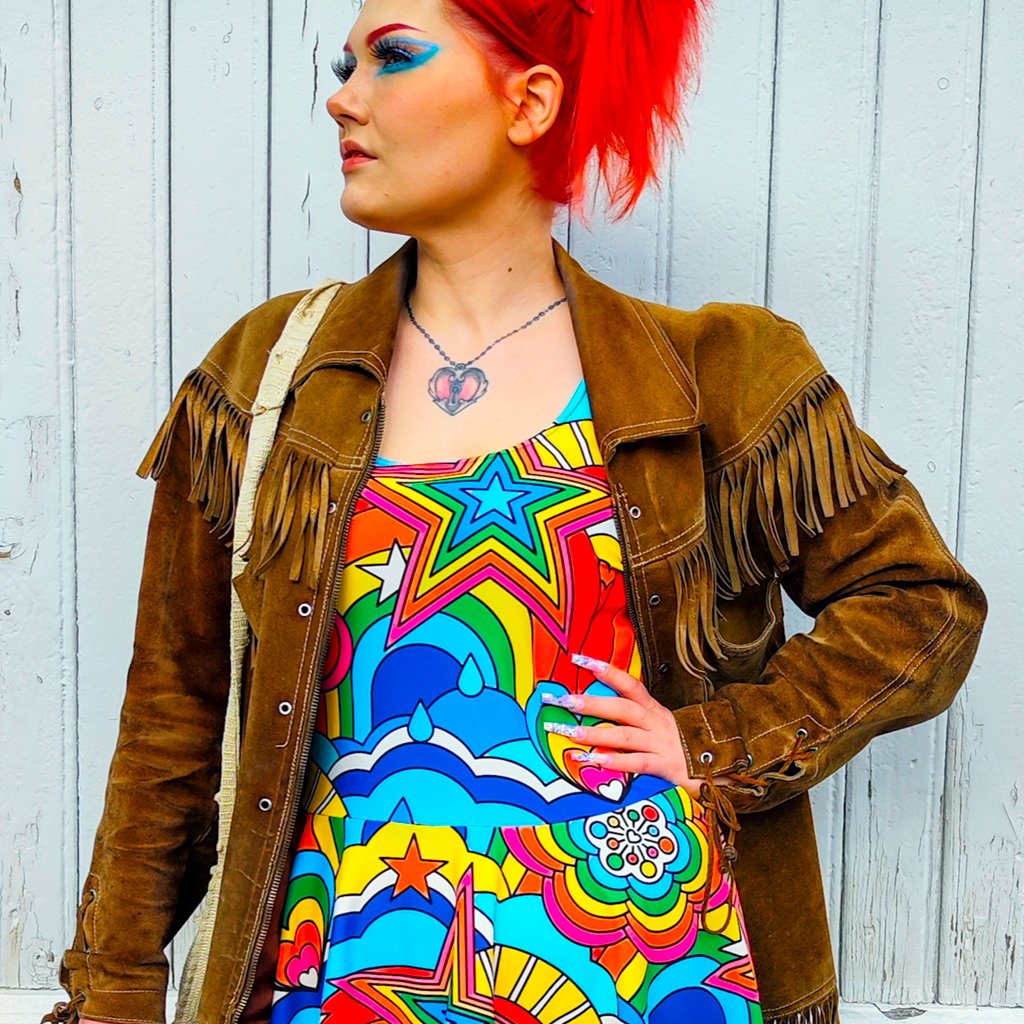 A woman in a skater dress with RAINBOW RAVE by SHALMIAK.