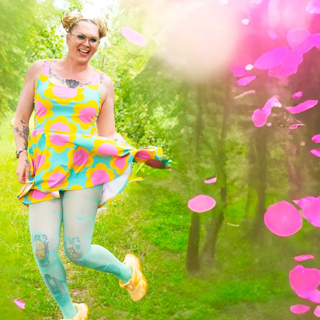 A woman in a colorful skater dress by SHALMIAK. Design: ELLIE.